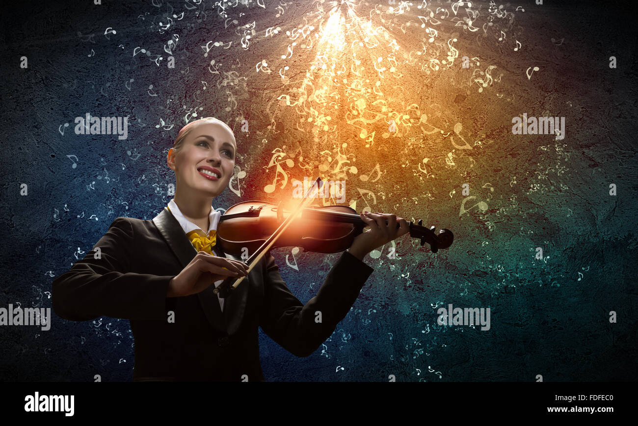 Image of young smiling businesswoman playing violin Stock Photo - Alamy