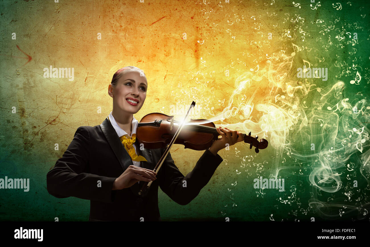Image of young smiling businesswoman playing violin Stock Photo - Alamy