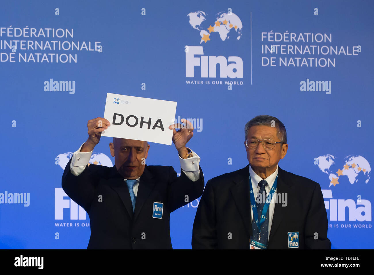 Budapest, Hungary. 31st Jan, 2016. FINA President Julio Maglione (L) holds up the card writing Doha to announce it as the host city of the 2023 World Aquatics Championships at a press conference in Budapest, Hungary, on Jan. 31, 2016. © Attila Volgyi/Xinhua/Alamy Live News Stock Photo