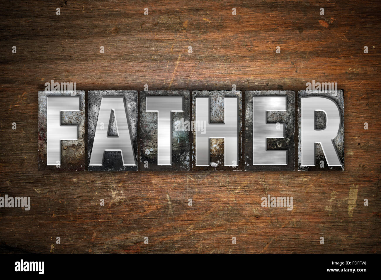 The word "Father" written in vintage metal letterpress type on an aged
