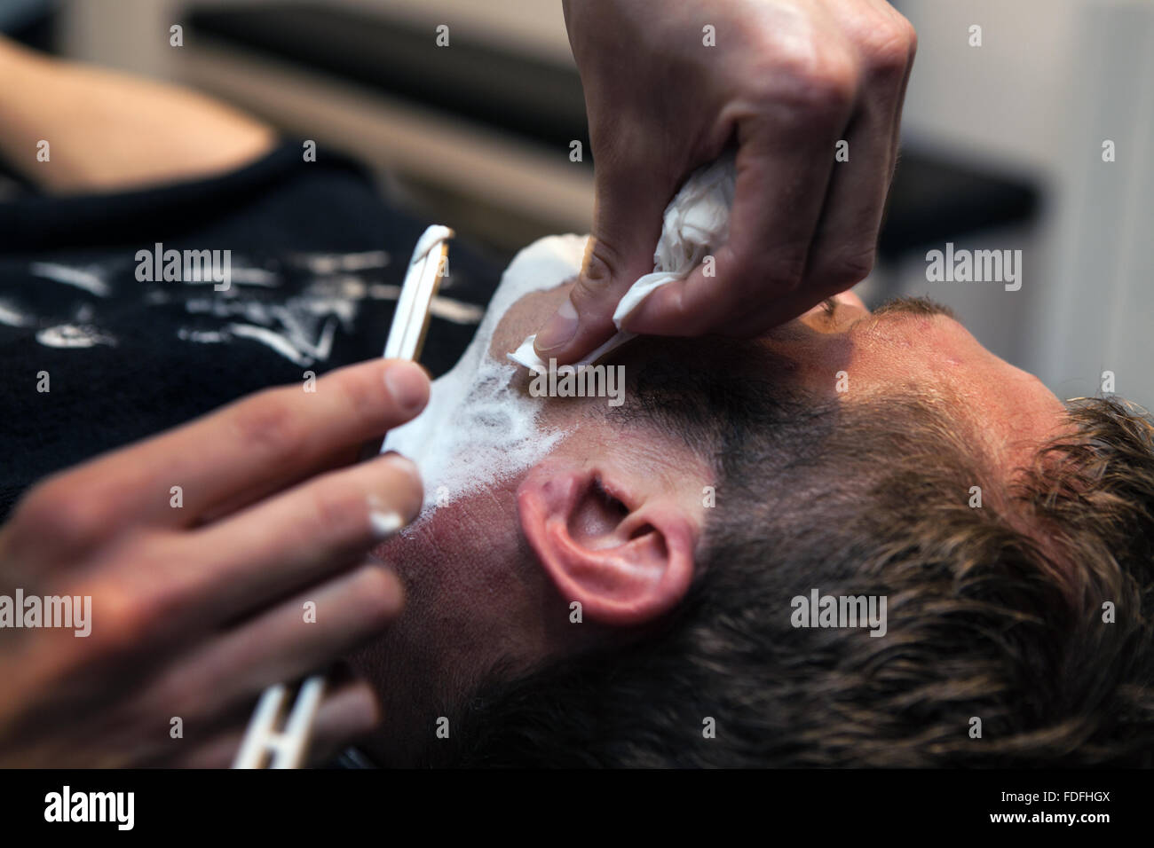 Having a shave at Cut-Throat London Barber and Parlour, Peckham, London Stock Photo