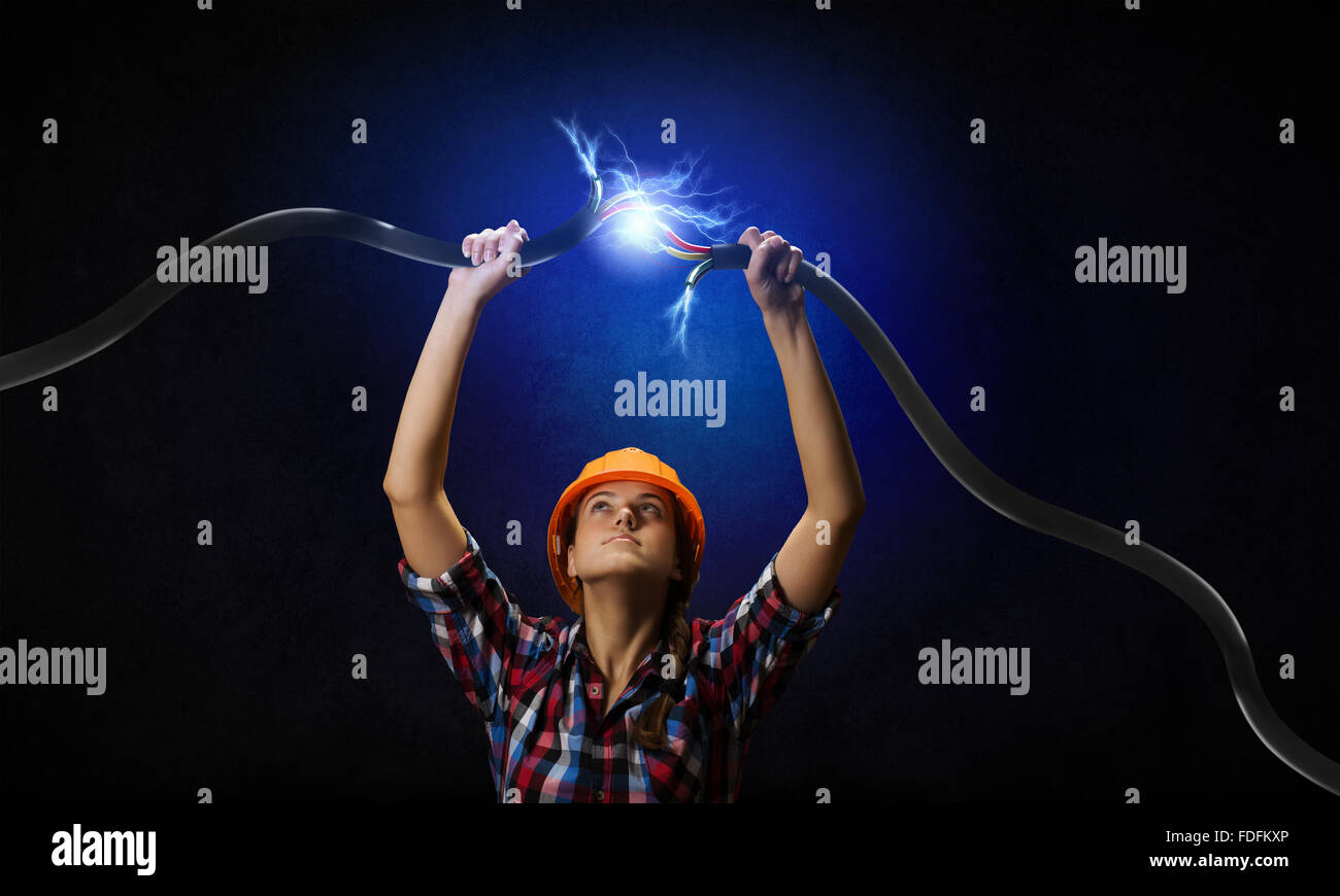 Image of woman holding electricity cable above head Stock Photo Alamy