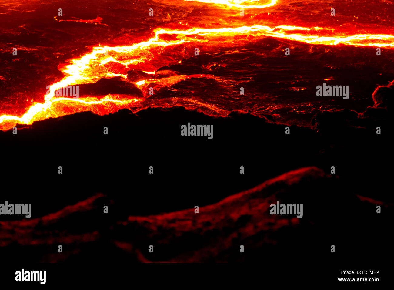 Bright lines show the cracks in the moving surface of Erta Ale's lava lake Stock Photo