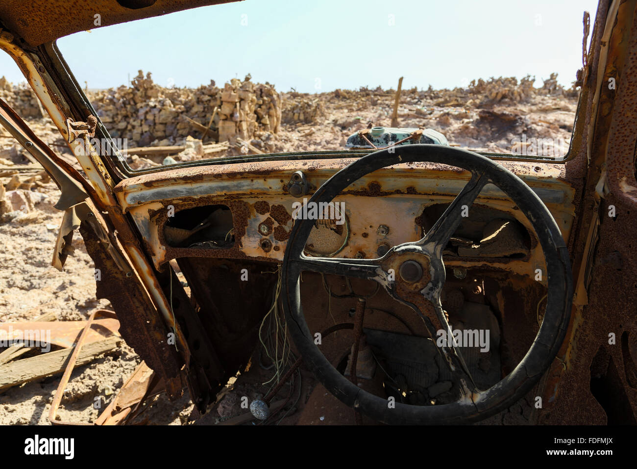 An ancient Fiat car slowly rots at an abandoned mineral extraction plant Stock Photo