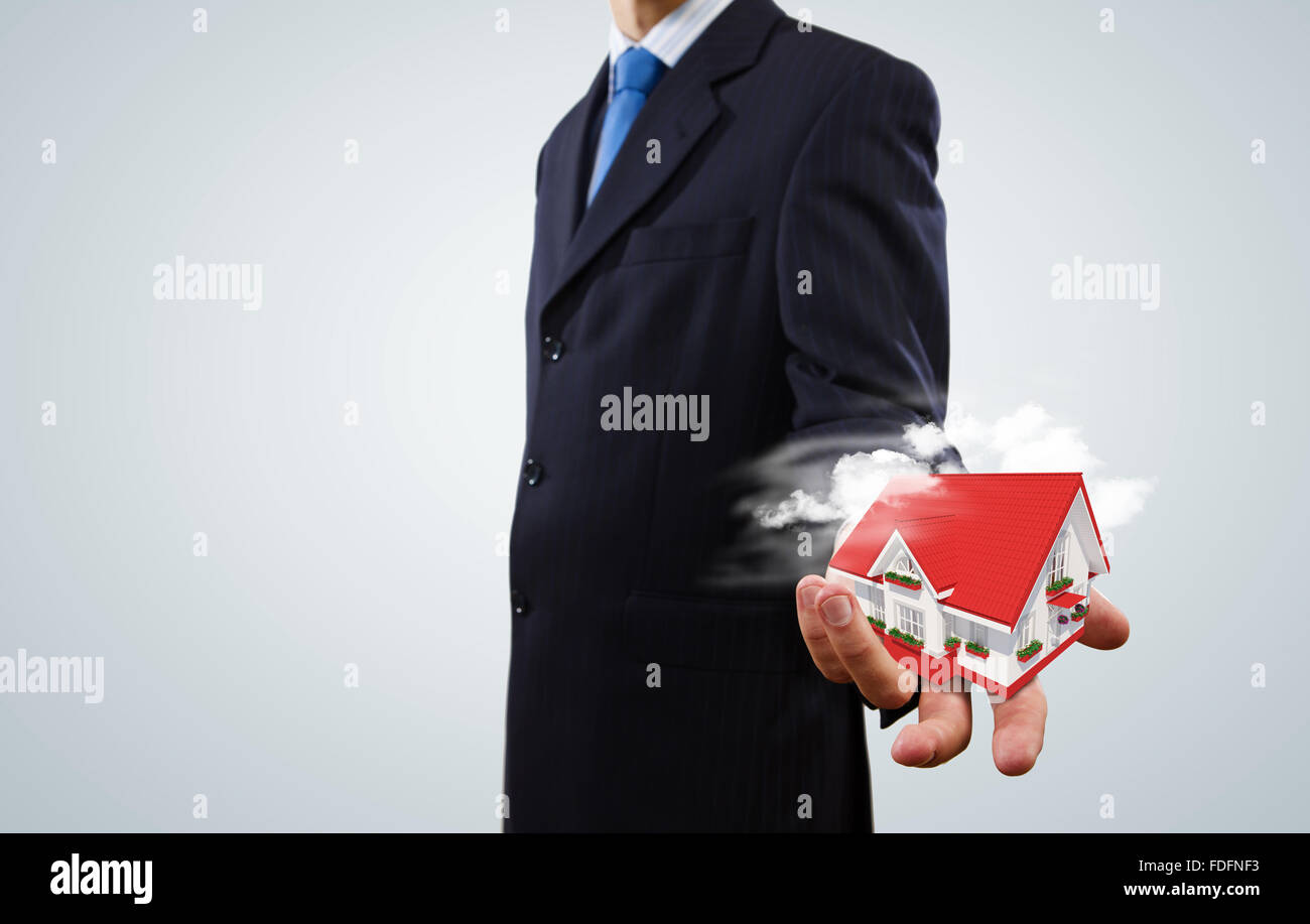 Close up of businessman holding house model in palm Stock Photo - Alamy