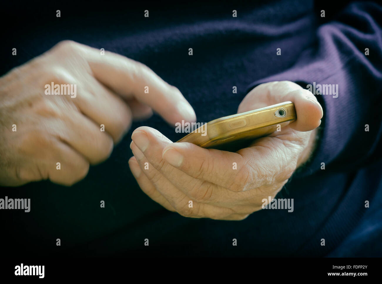 Male hands entering information on smart phone. Stock Photo