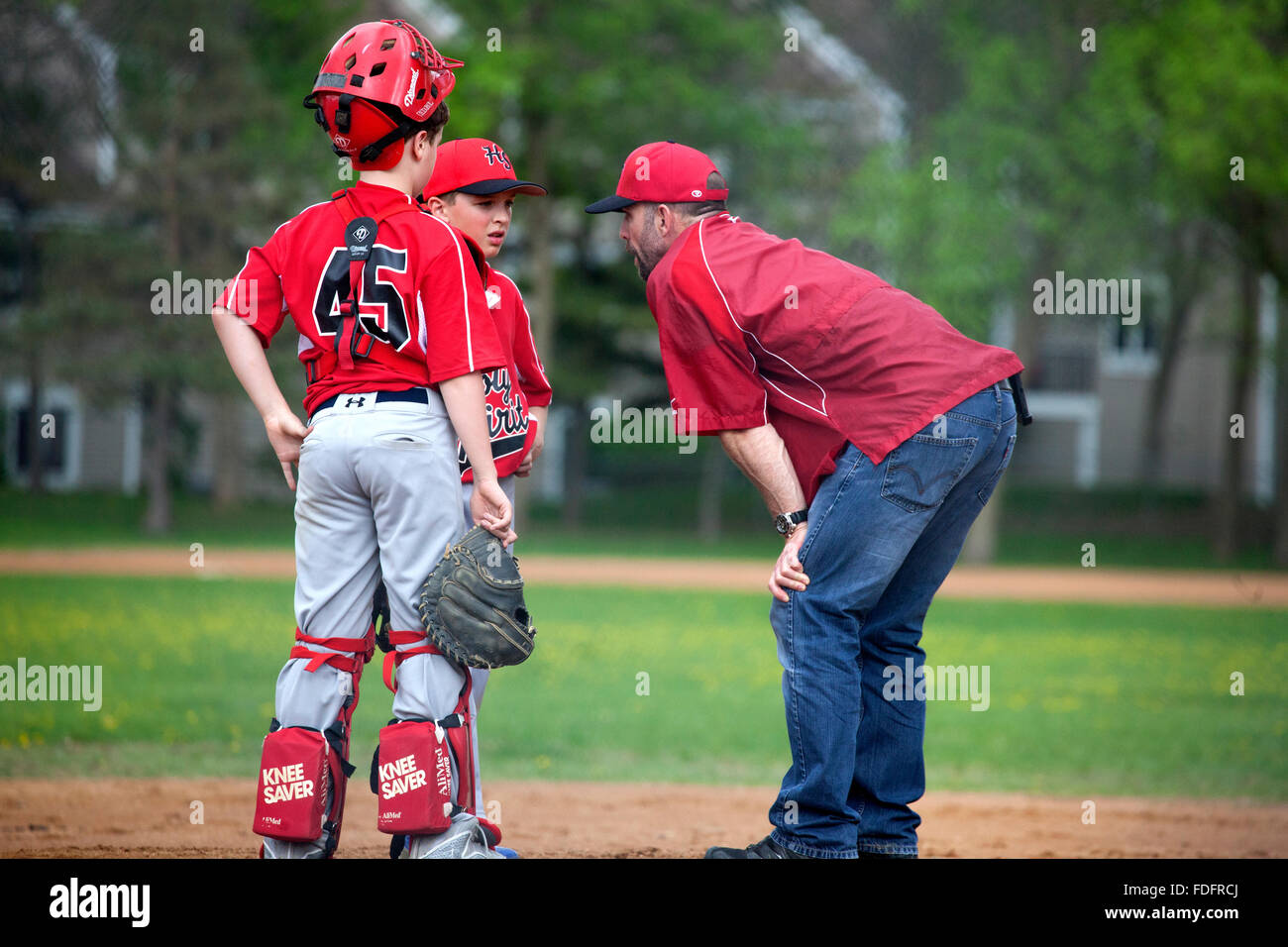 Coach Pitcher And Catcher Discussing The Progress Of The Little Stock Photo Alamy