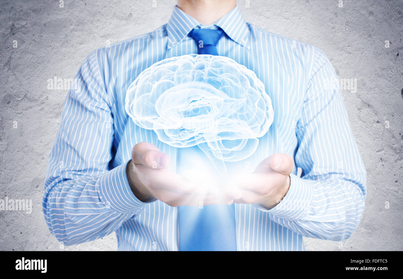 Close up of businessman holding image of brain in hands Stock Photo - Alamy