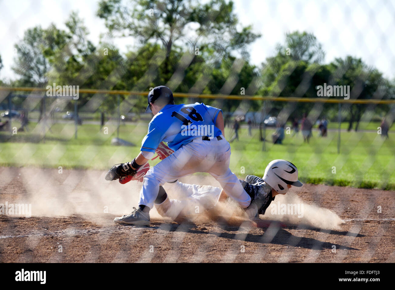 Young baseball player age, boy 12, slides head first into base. Blaine Minnesota MN USA Stock Photo