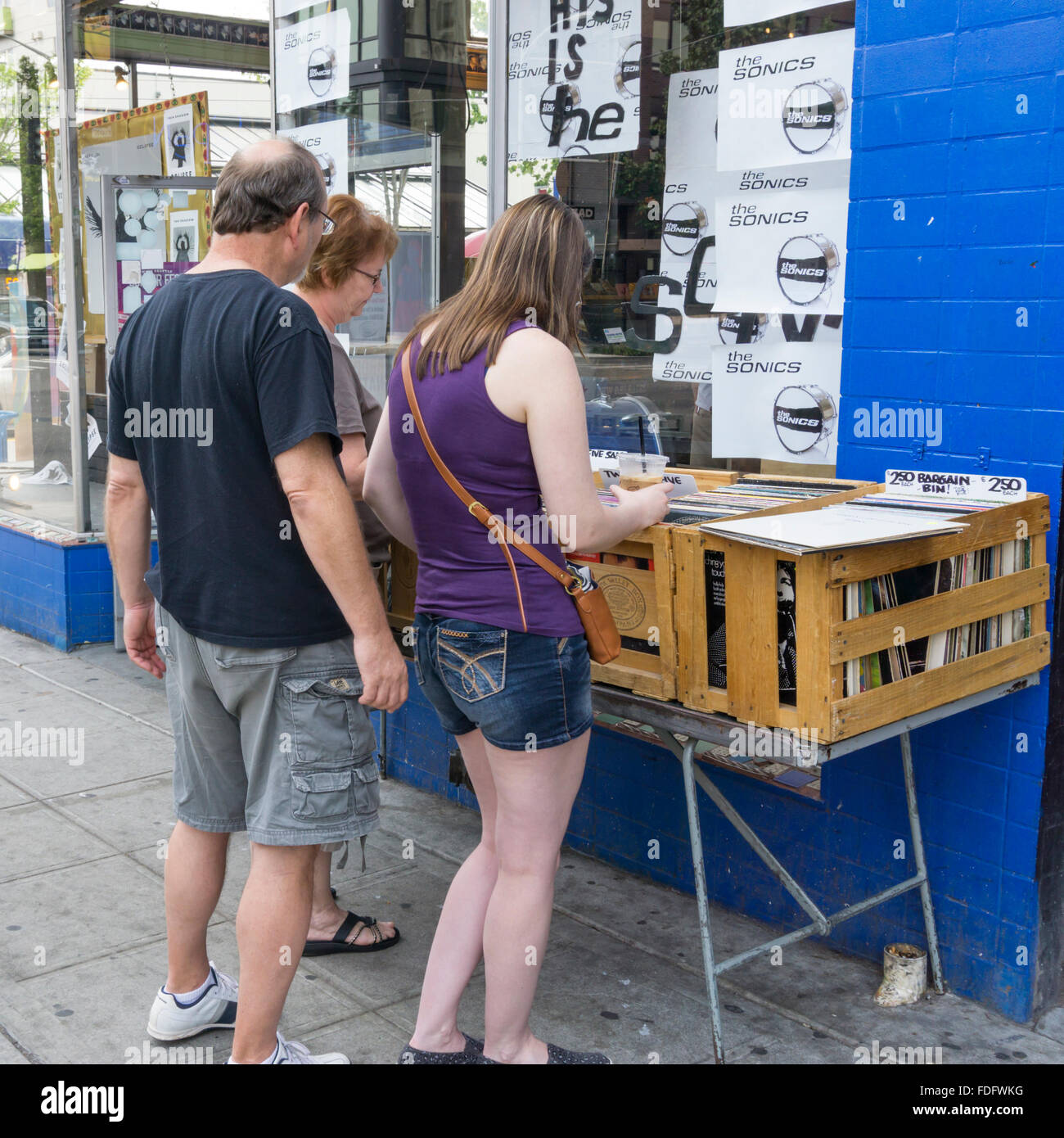 People looking in the bargain bin outside Easy Street Records in West Seattle. Stock Photo