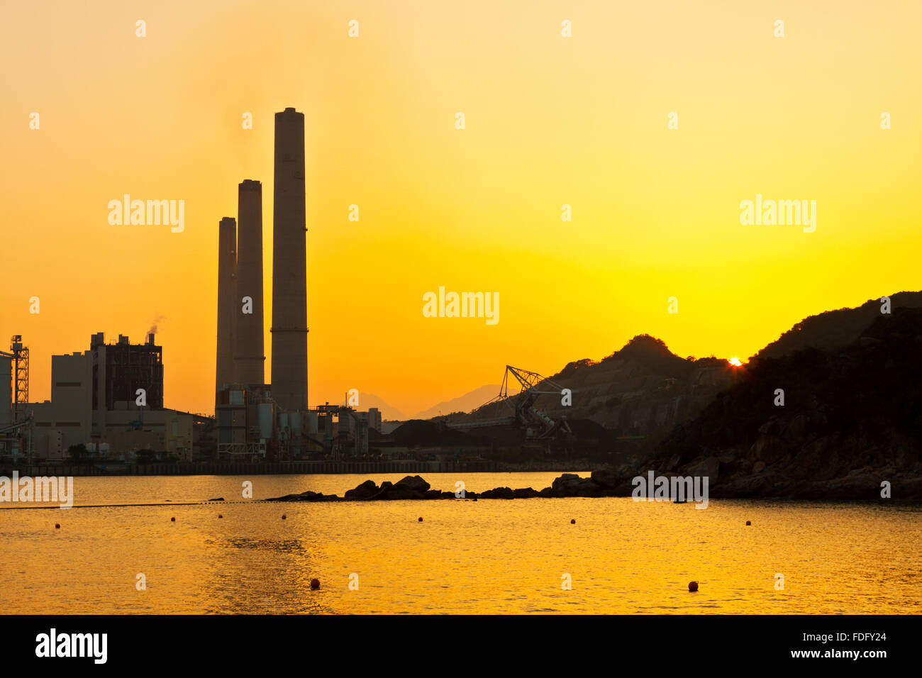 Power station along coast at sunset in Hong Kong Stock Photo