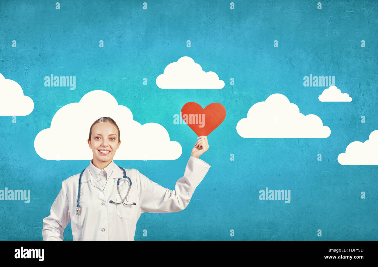 Young female doctor holding red heart in hands Stock Photo - Alamy