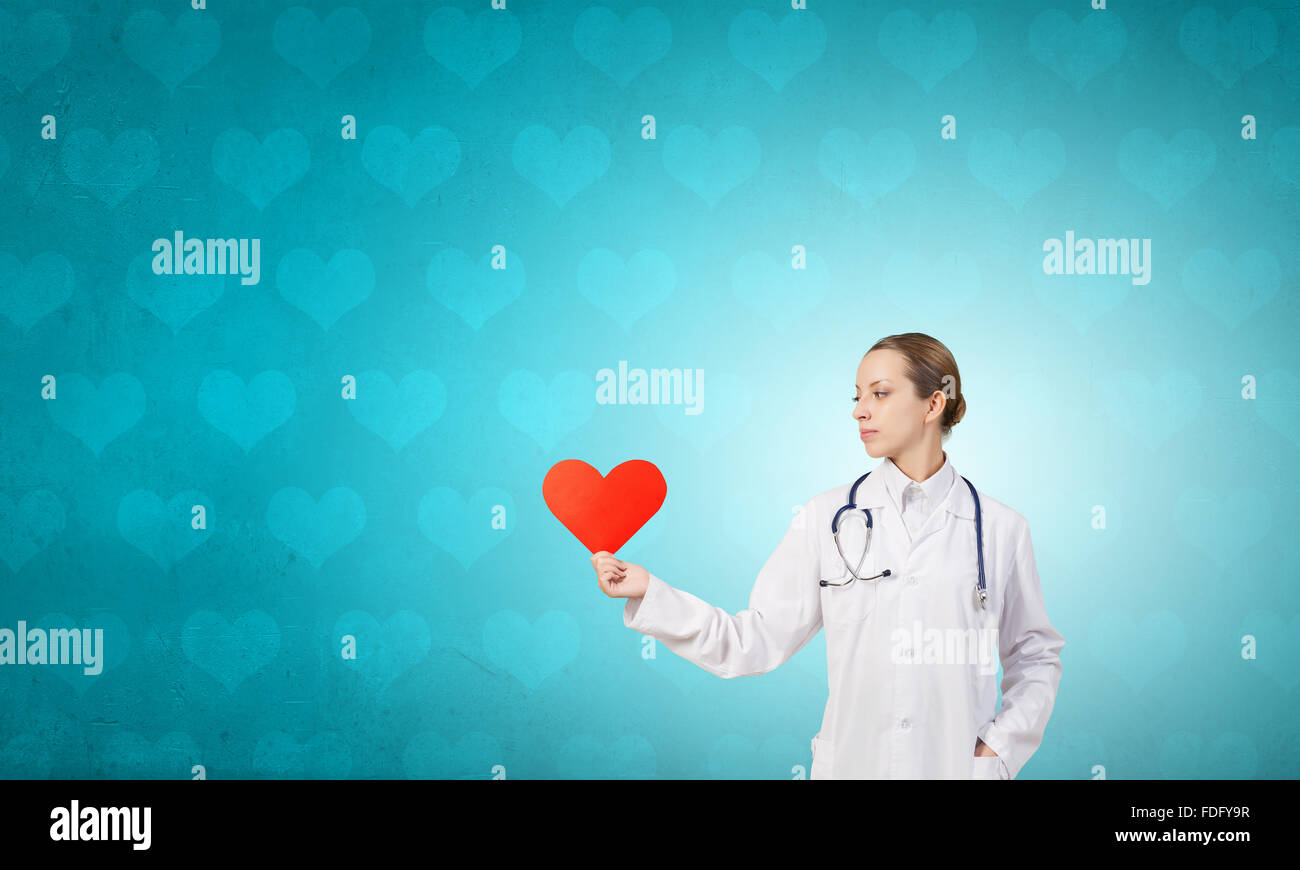 Young female doctor holding red heart in hands Stock Photo - Alamy