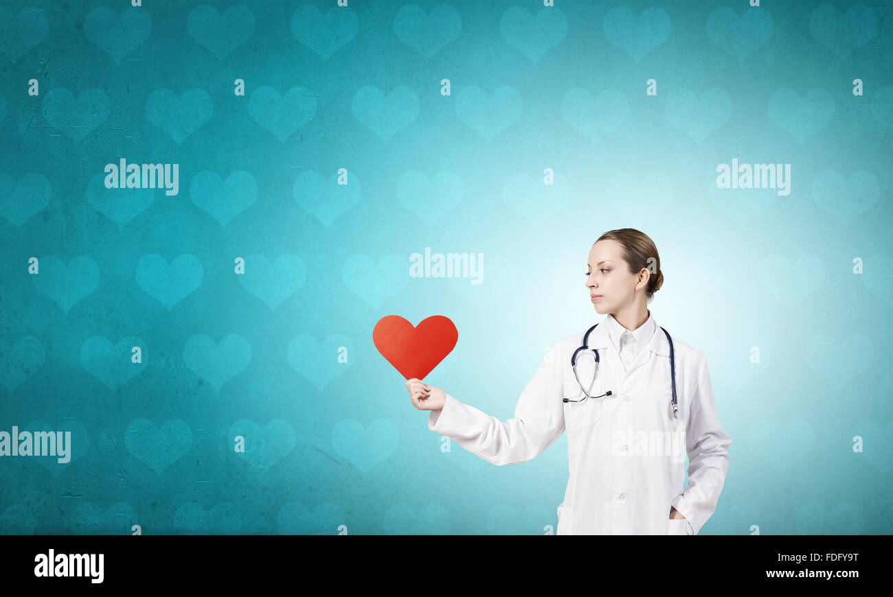 Young female doctor holding red heart in hands Stock Photo - Alamy