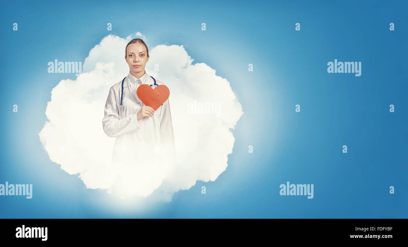 Young female doctor holding red heart in hands Stock Photo - Alamy