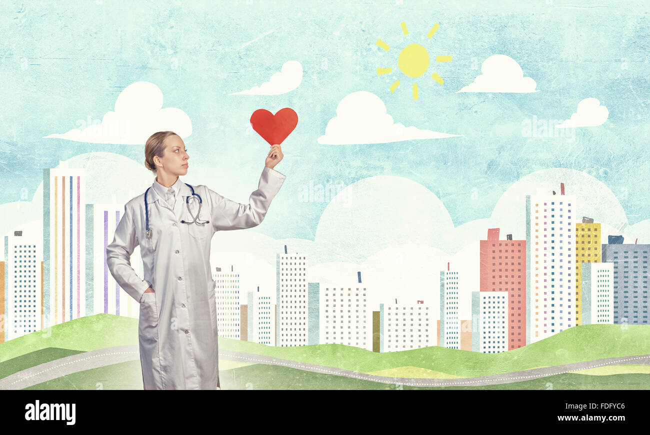 Young female doctor holding red heart in hands Stock Photo - Alamy