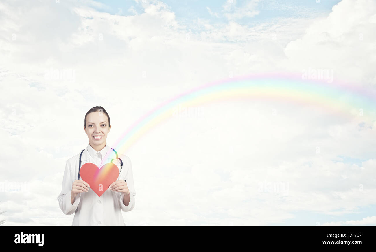Young female doctor holding red heart in hands Stock Photo - Alamy