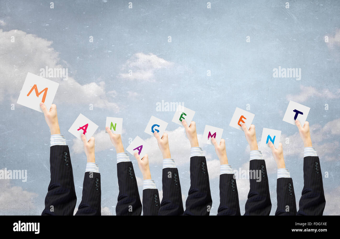 Group of business people holding in hands cards with letters Stock ...