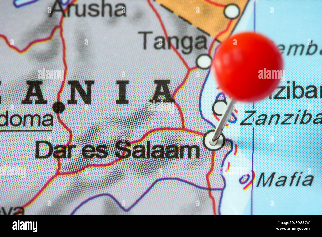 Close-up of a red pushpin in a map of Dar es Salaam, Tanzania. Stock Photo