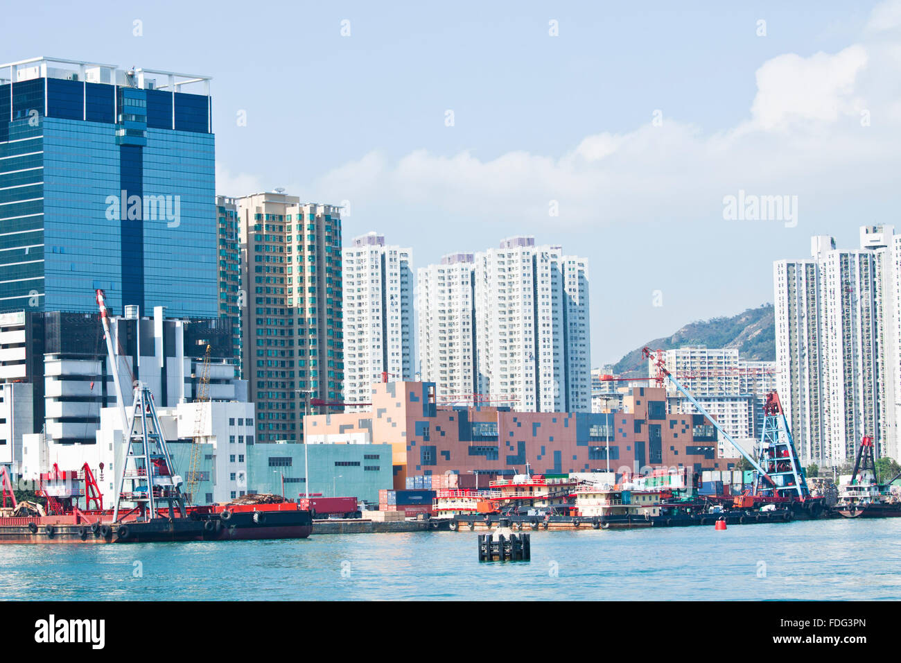 Hong Kong apartment blocks and fishing boats at coast Stock Photo