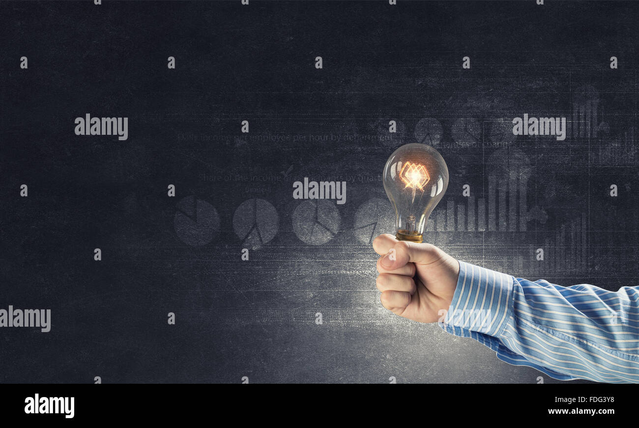 Close up of hand holding glowing light bulb Stock Photo - Alamy