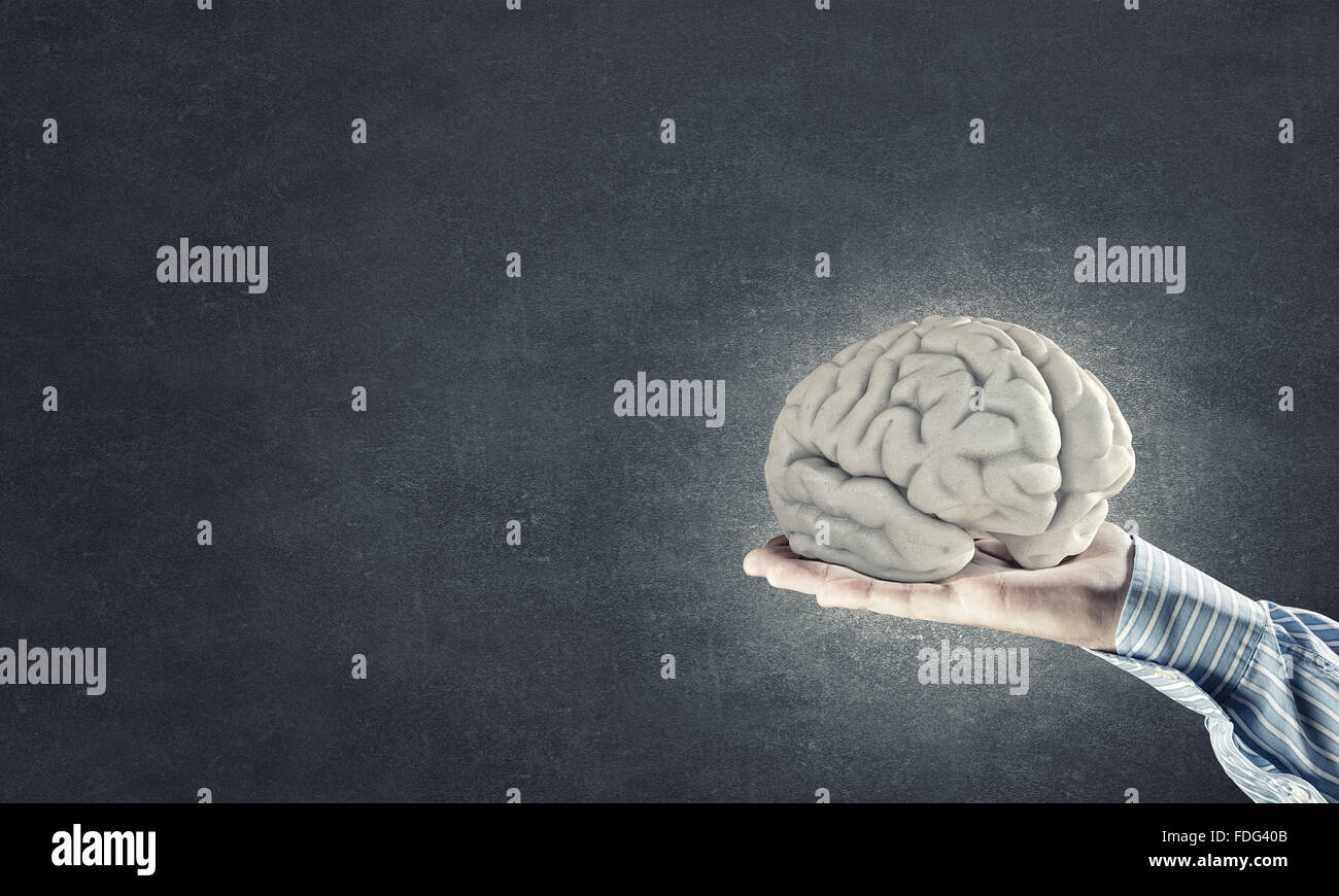 Close up of businessman hand holding brain Stock Photo - Alamy