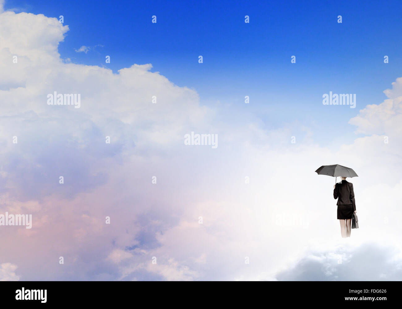 Young businesswoman with black umbrella standing on cloud Stock Photo ...