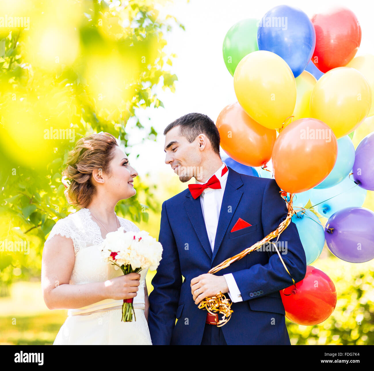 Happy bride and groom with balloons Stock Photo - Alamy