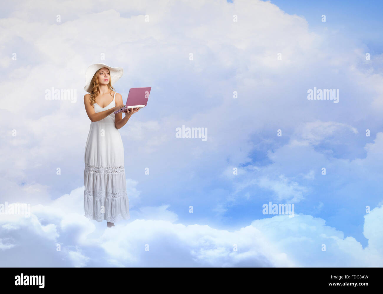 Young lady standing on cloud and using laptop Stock Photo - Alamy