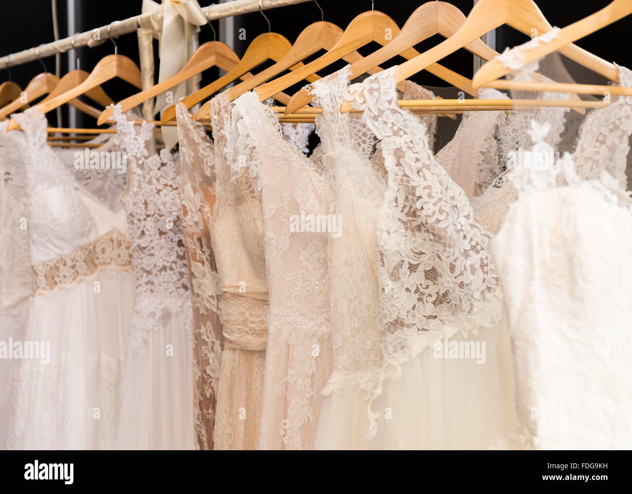 wedding dresses hanging on racks Stock Photo Alamy