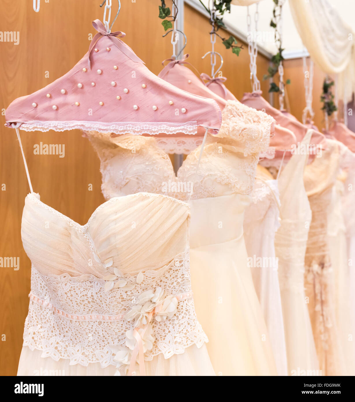 wedding dresses hanging on racks Stock Photo Alamy