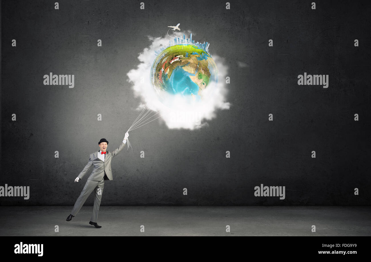 Businessman catch Earth planet with rope . Elements of this image are ...