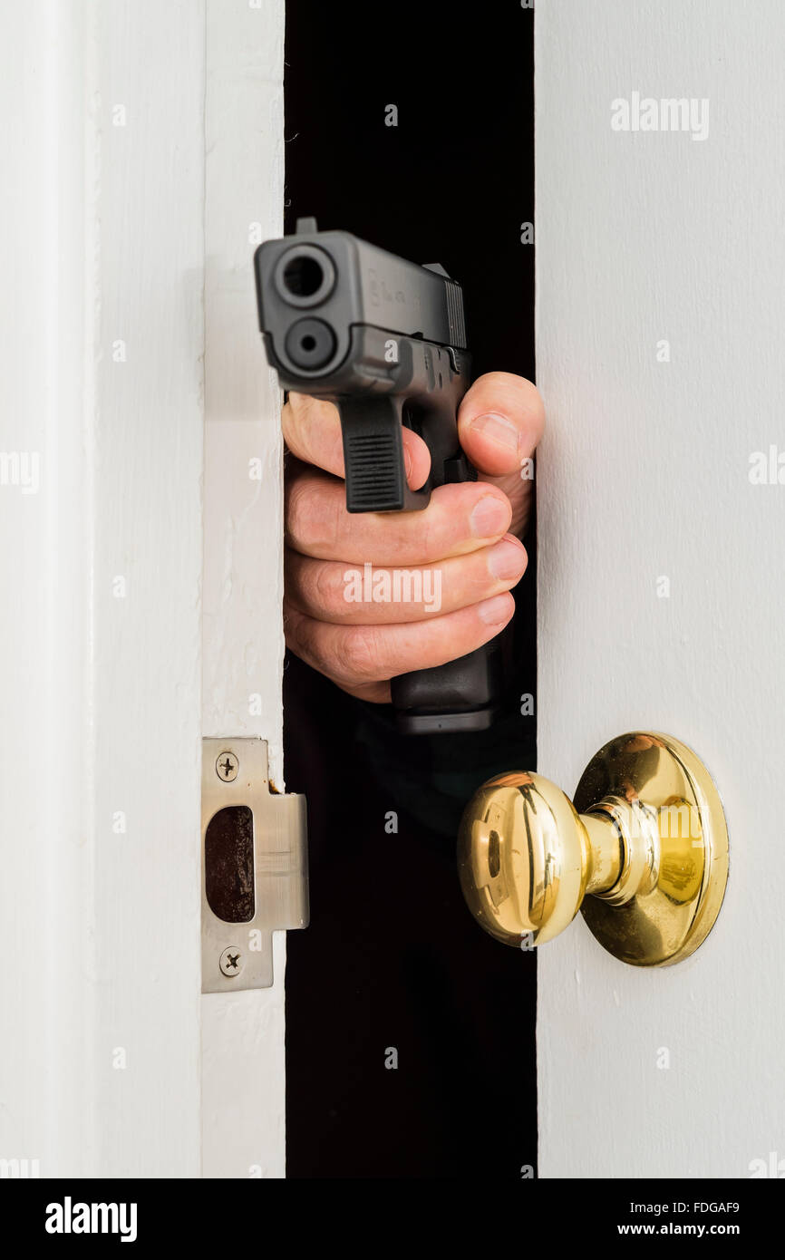 The hand with the gun in the doorway Stock Photo Alamy