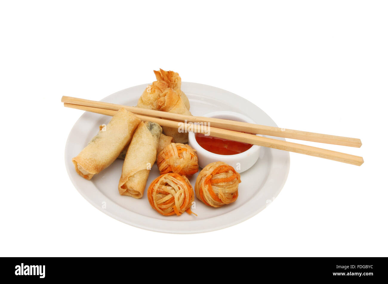 Oriental appetizers with sweet chili dipping sauce and chopsticks on a
