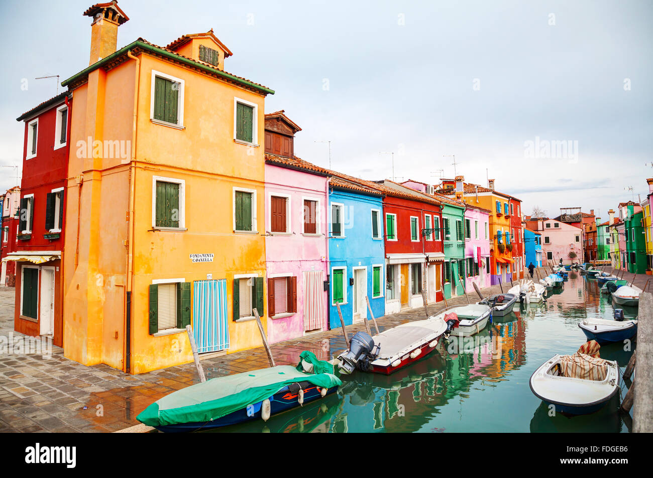 BURANO, ITALY - NOVEMBER 23: Brightly painted houses at the Burano canal on November 23, 2015 in Burano, Venice, Italy. Stock Photo
