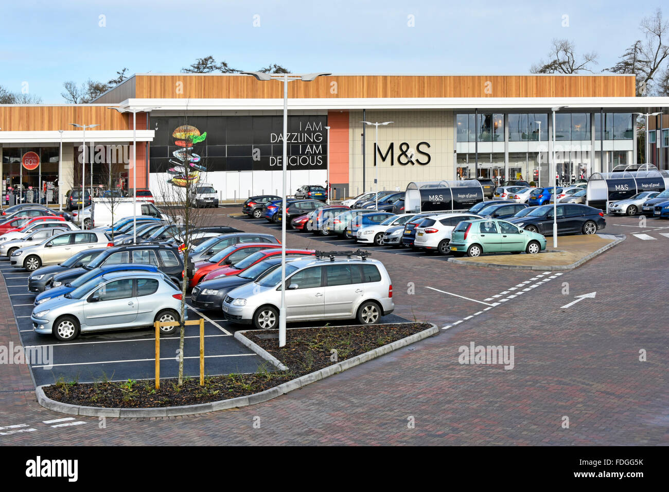 M&S sign on Marks and Spencer retail store at Elliotts Field shopping centre busy free car parking in Rugby Warwickshire West Midlands England UK Stock Photo