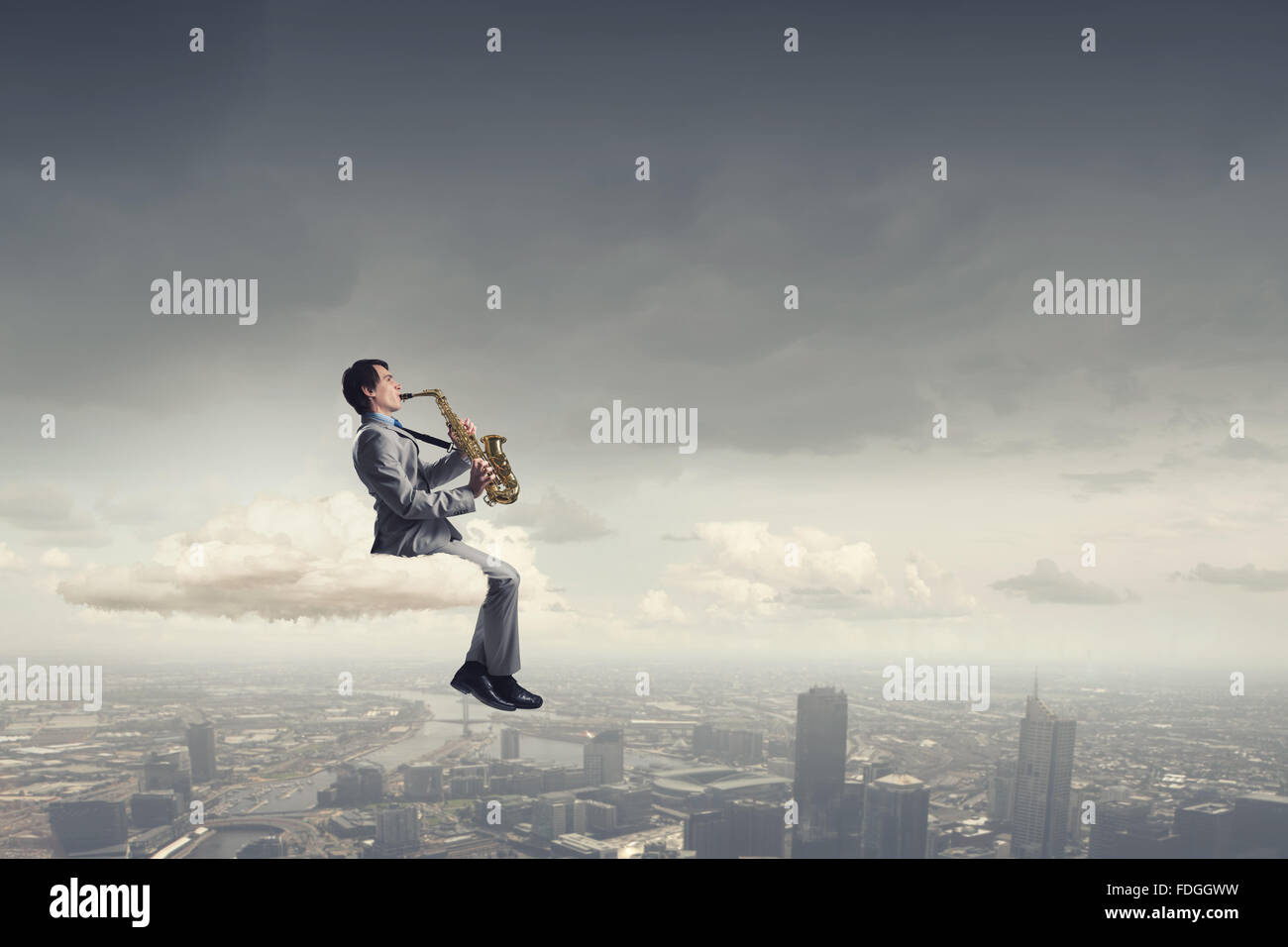 Young man sitting on cloud playing saxophone Stock Photo Alamy