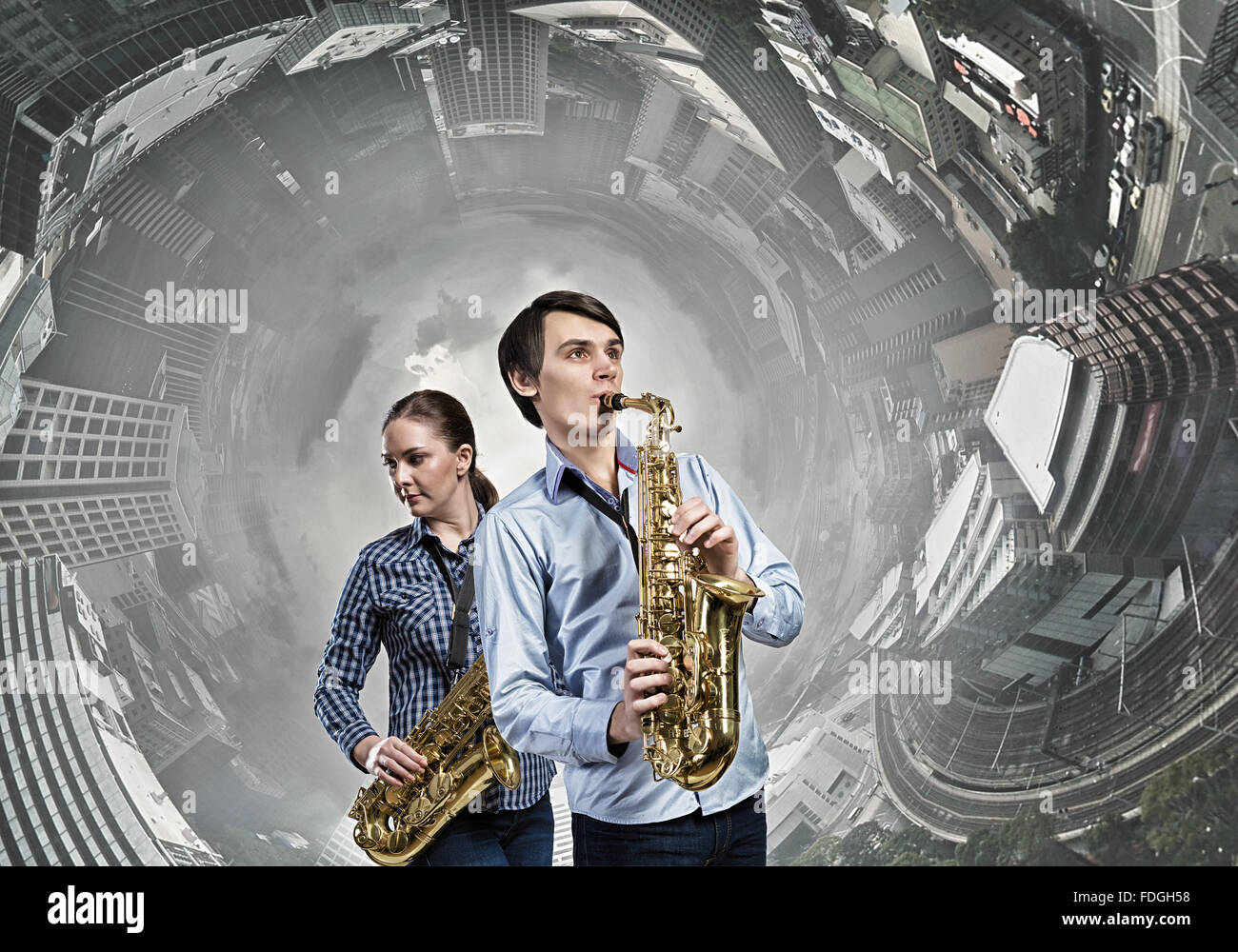 Duet of young man and woman musicians playing saxophones Stock Photo ...