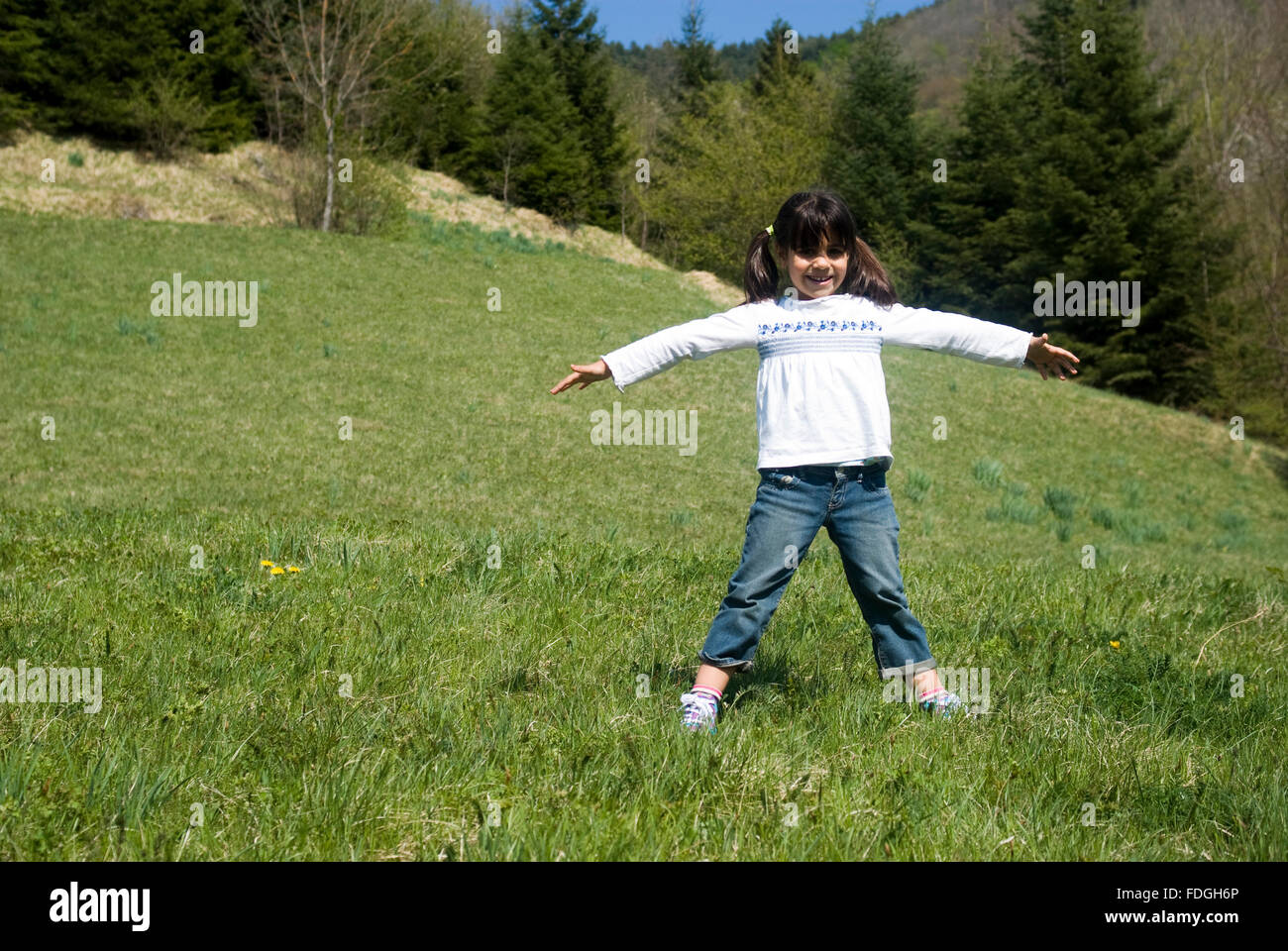 Happy girl playing in the park Stock Photo - Alamy
