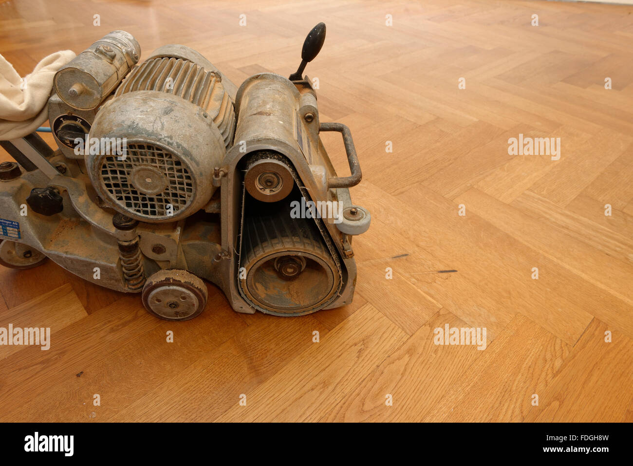 A grinding machine for wooden parquet floors on a oak parquet Stock ...