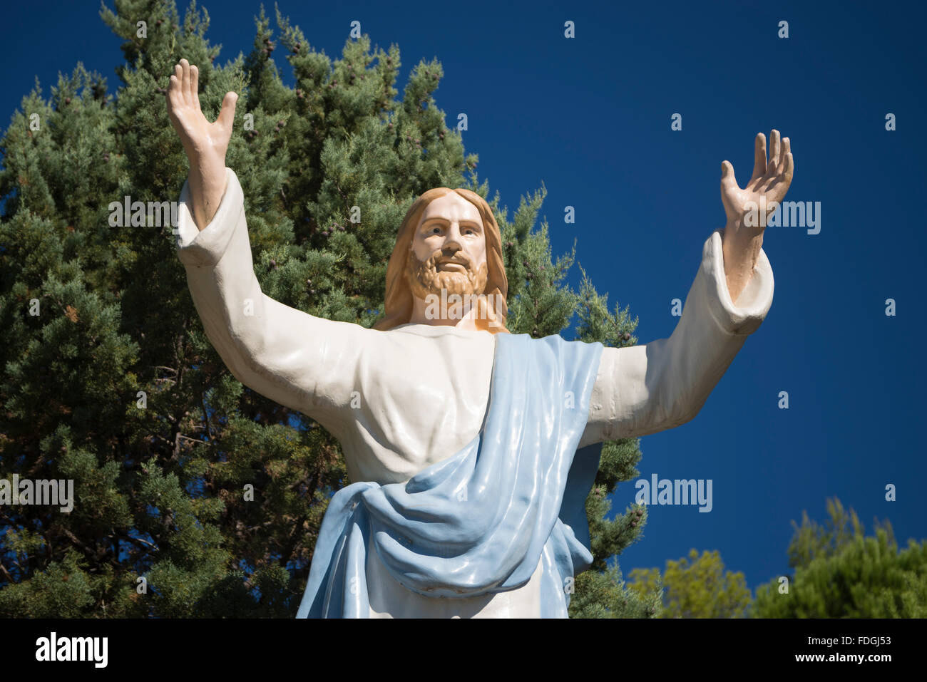Larger than life statue of Jesus spreads out his hands for the blessing, Camerota, Cilento, Campania, Italy Stock Photo