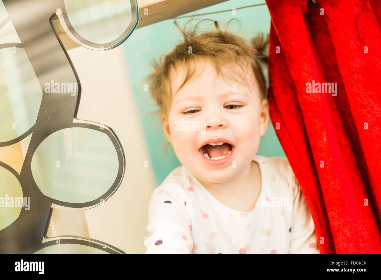 Cute toddler girl playing with toy puppet theater Stock Photo Alamy
