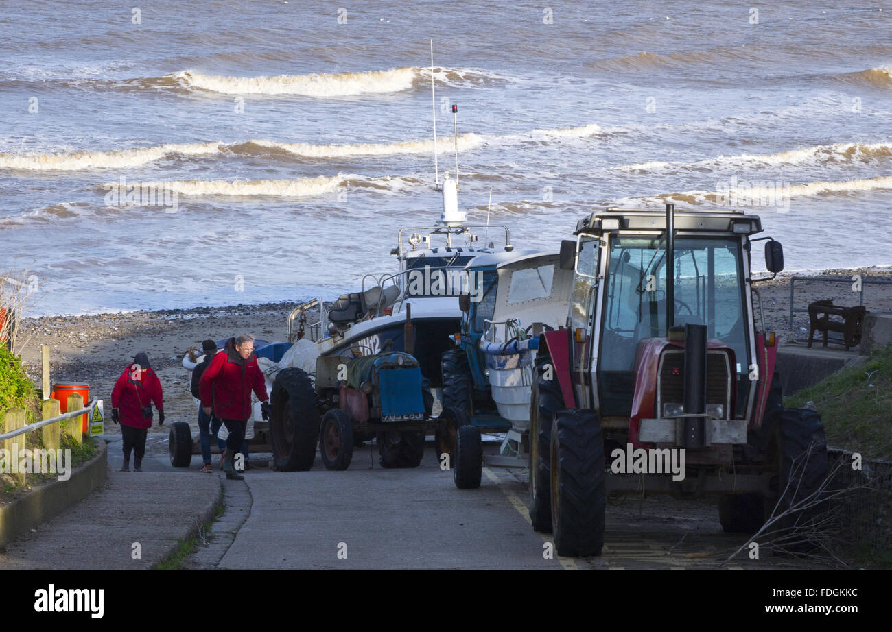 fishing boats tractors East Runton gap Stock Photo Alamy