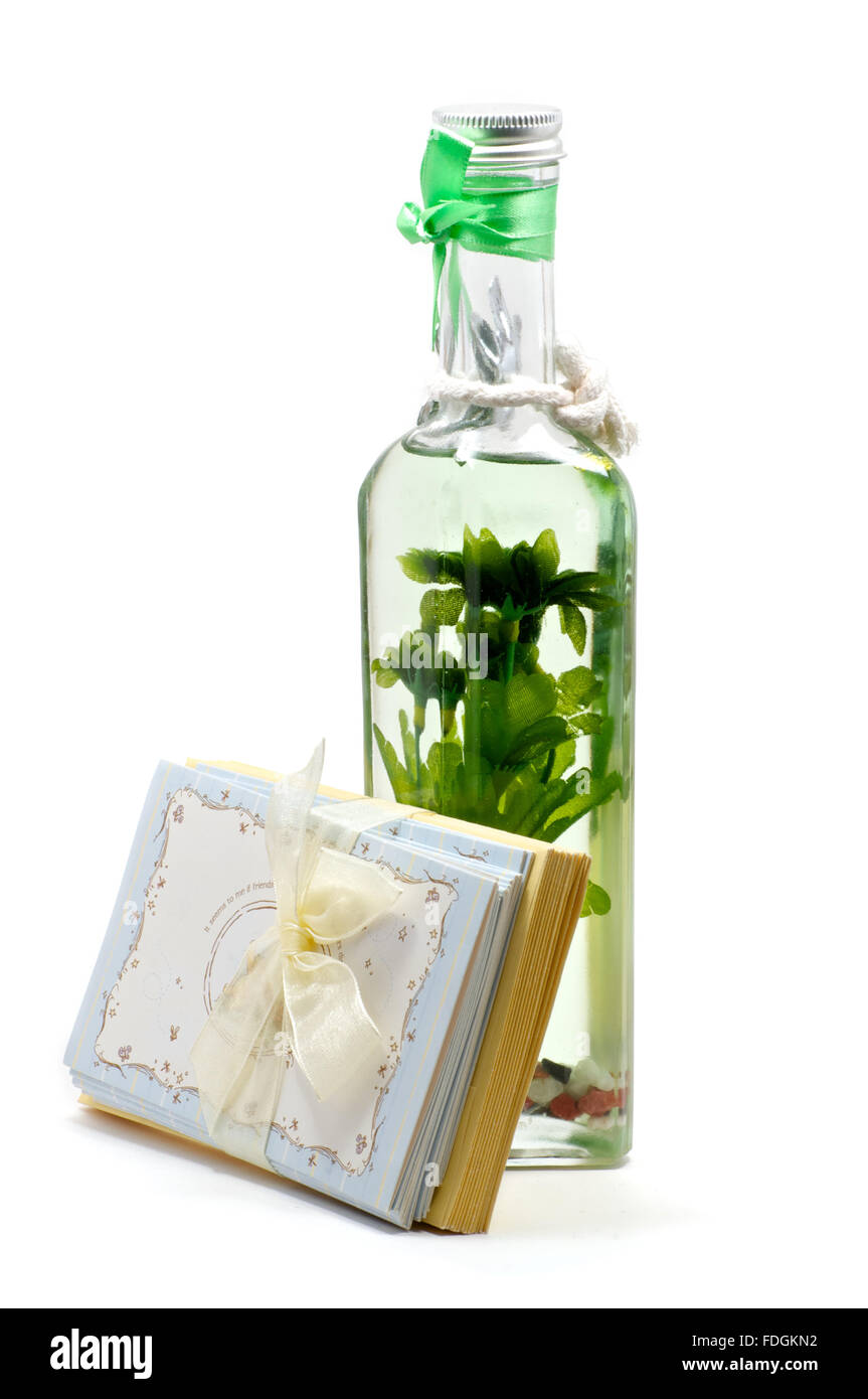 Green aromatic oil candle with flower inside and greeting cards leaned Stock Photo
