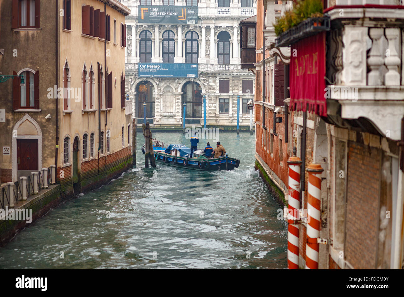Transporting with small boats on canals in Venice Italy Stock Photo
