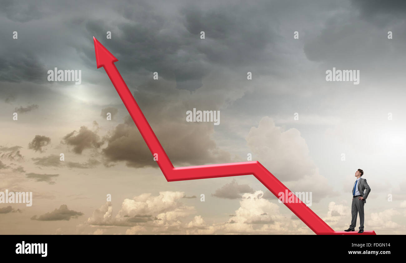 Confident businessman standing on red growing arrow graph Stock Photo ...