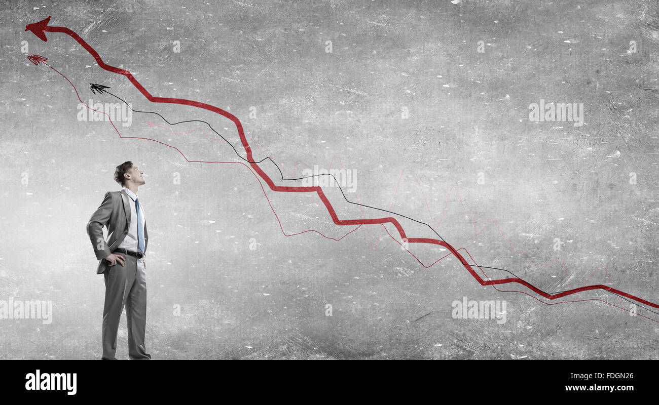 Confident businessman with arms on waist and red growing arrow graph ...
