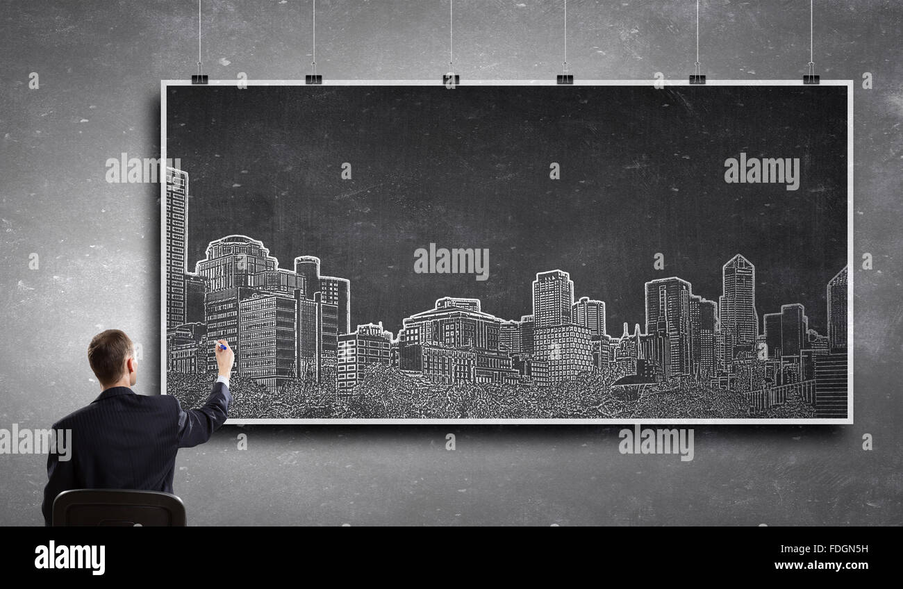 Rear View Of Businessman Drawing Construction Project On Banner