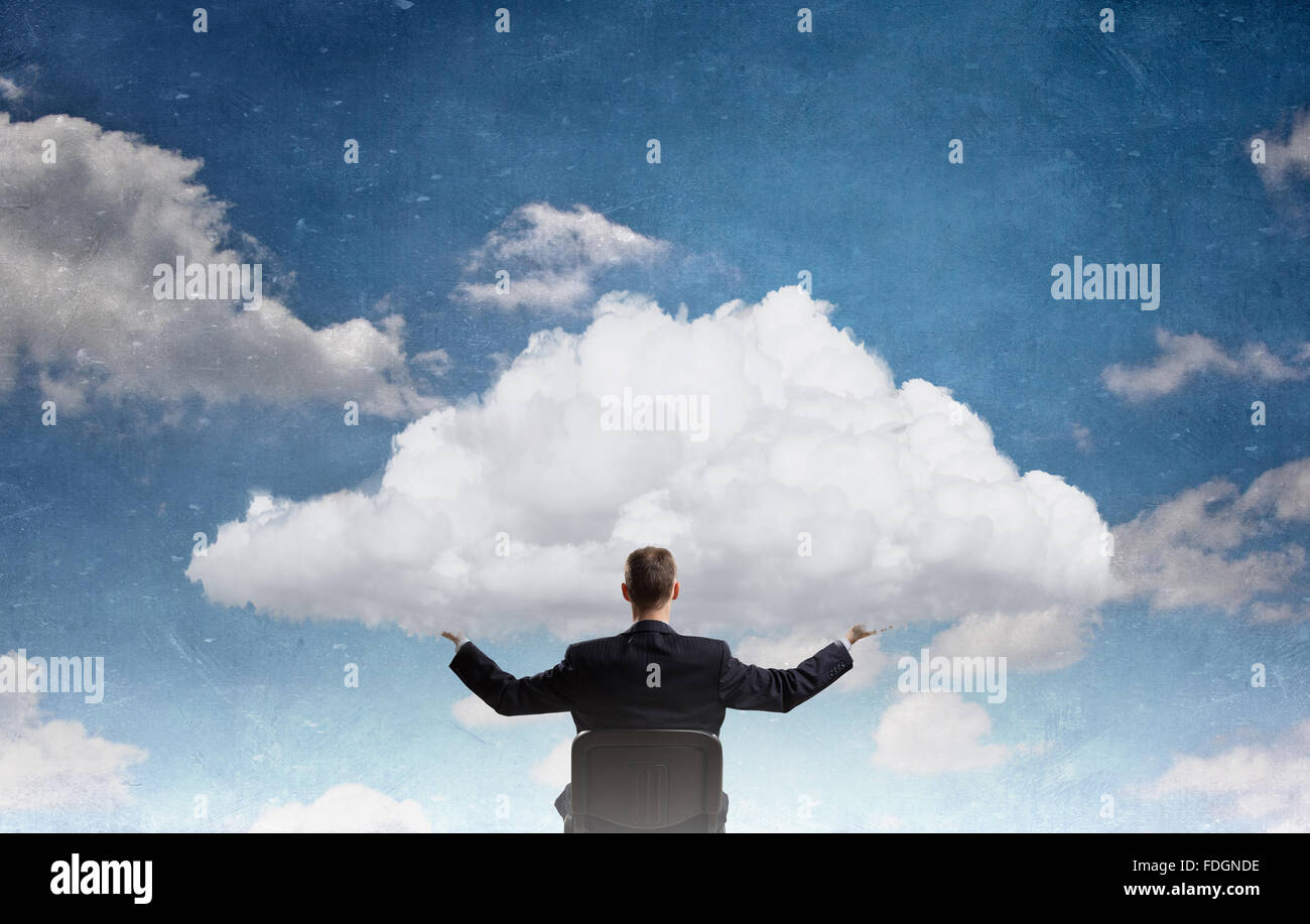Back view of businessman in chair holding white cloud Stock Photo - Alamy