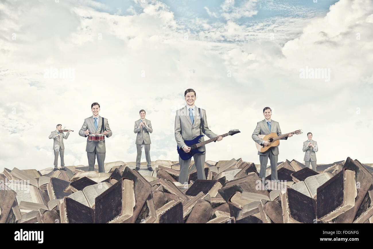 Man orchestra in suit playing different music instruments Stock Photo ...